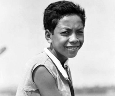 Photo: Akiu, a young boy who helped Australian soldiers in World War II. Source The ABC (Supplied: Australian War Memorial)